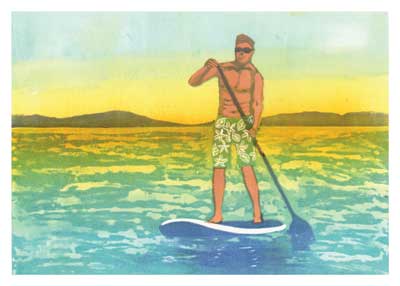 Man paddleboarding on calm water during a colorful sunset with distant hills in the background.