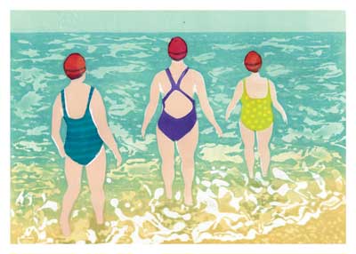 Three women in swimsuits and red swim caps standing in shallow ocean water with waves.