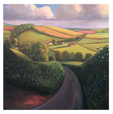 Curving country road with green hedges leading to rolling fields and farm buildings under a cloudy sky.