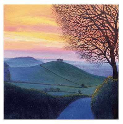 Sunset sky with pink and orange hues above rolling green hills and a bare tree in the foreground.